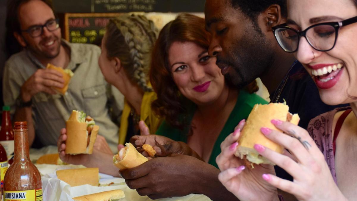 a close up of a man and a woman eating a hot dog